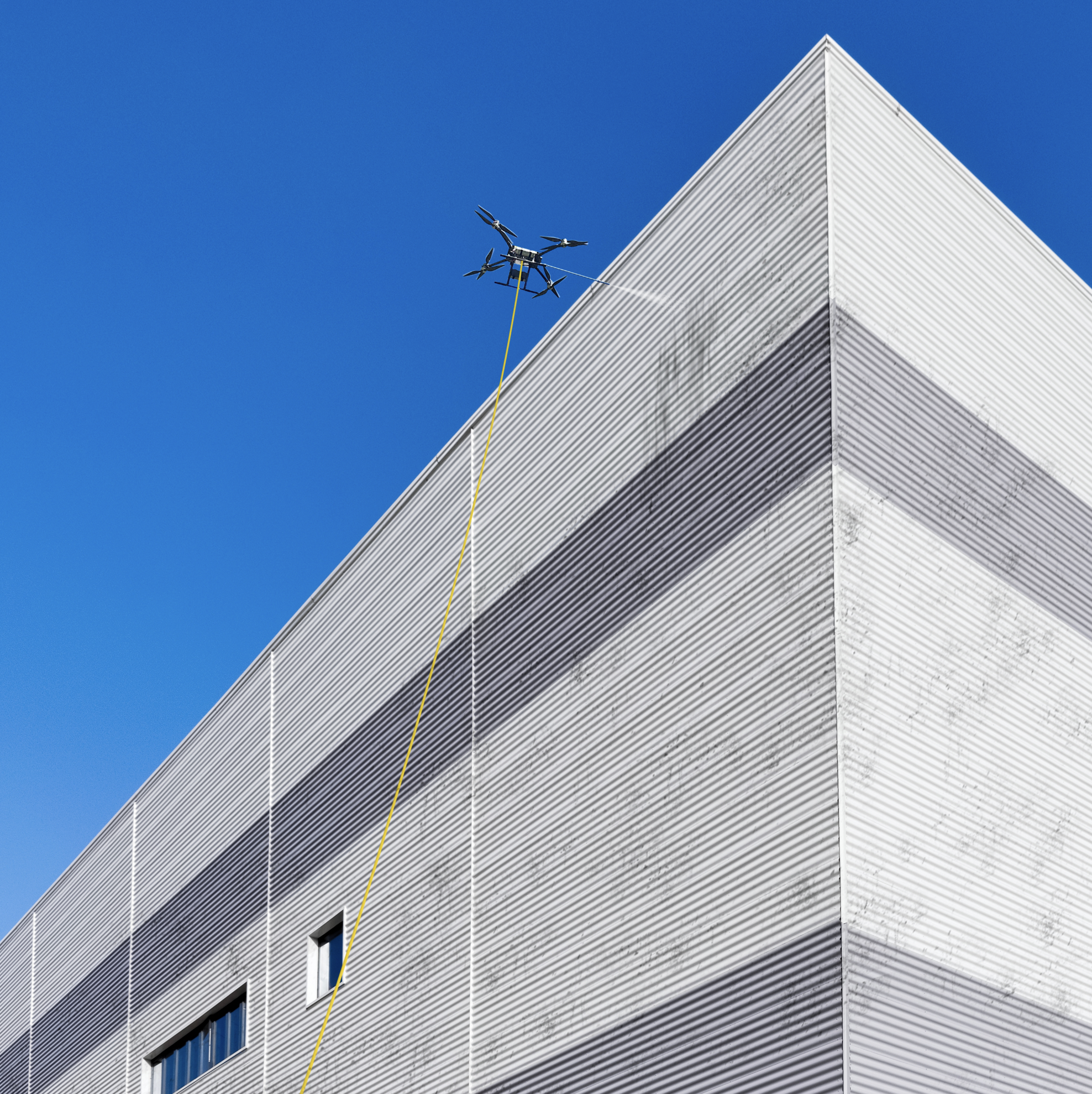 Image of a drone cleaning a commercial warehouse taken from below.